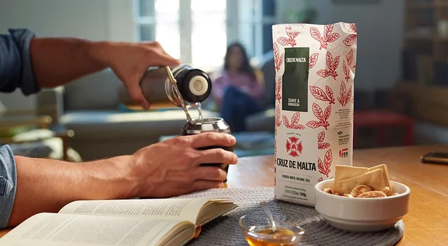Yerba mate poured beside the traditional CRUZ DE MALTA bag